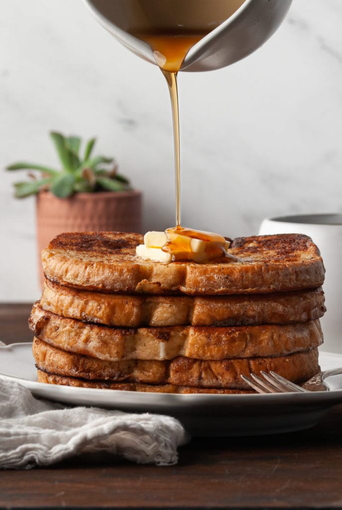 stack of sourdough french toast with syrup being poured on top