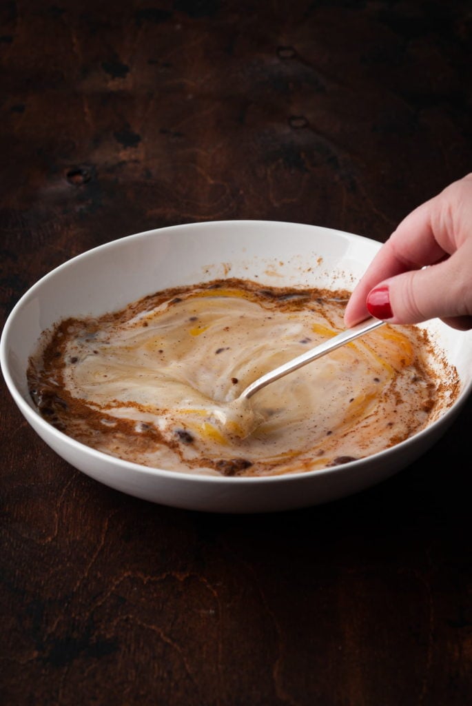 whisking together ingredients for egg wash for sourdough french toast