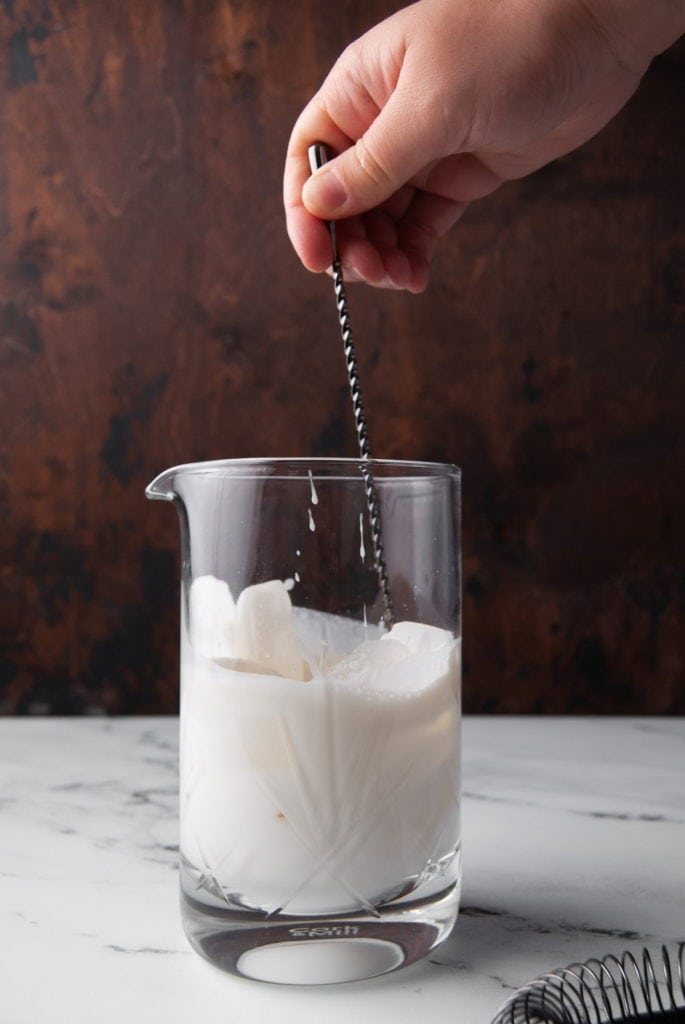 mixing white chocolate martini with ice in a mixing glass