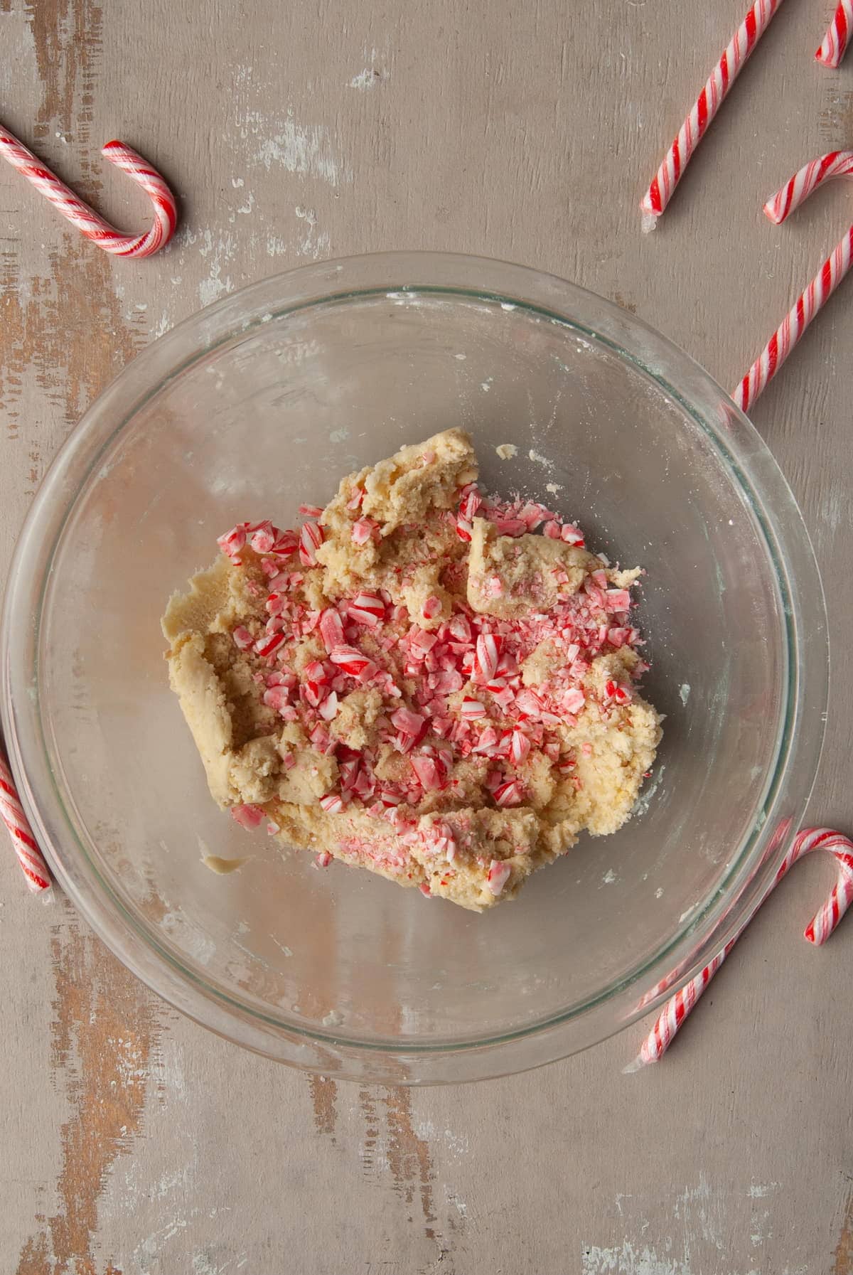 adding crushed candy cane to shortbread cookie dough
