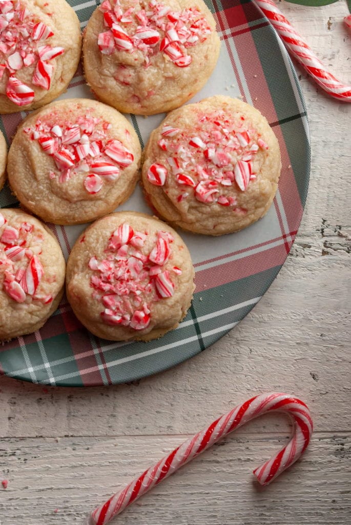 overhead shot of candy cane shortbread cookies on a christmas themed plate