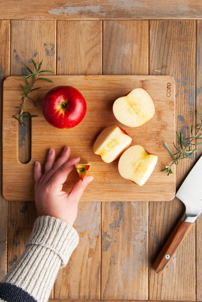 chopping an apple into 3 parts around the core