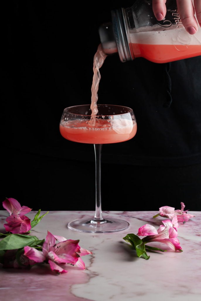 pouring a Love Potion Cocktail into a cocktail glass