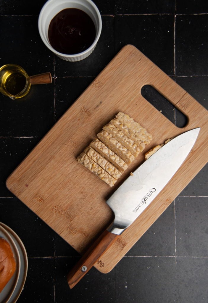 slicing a block of tempeh