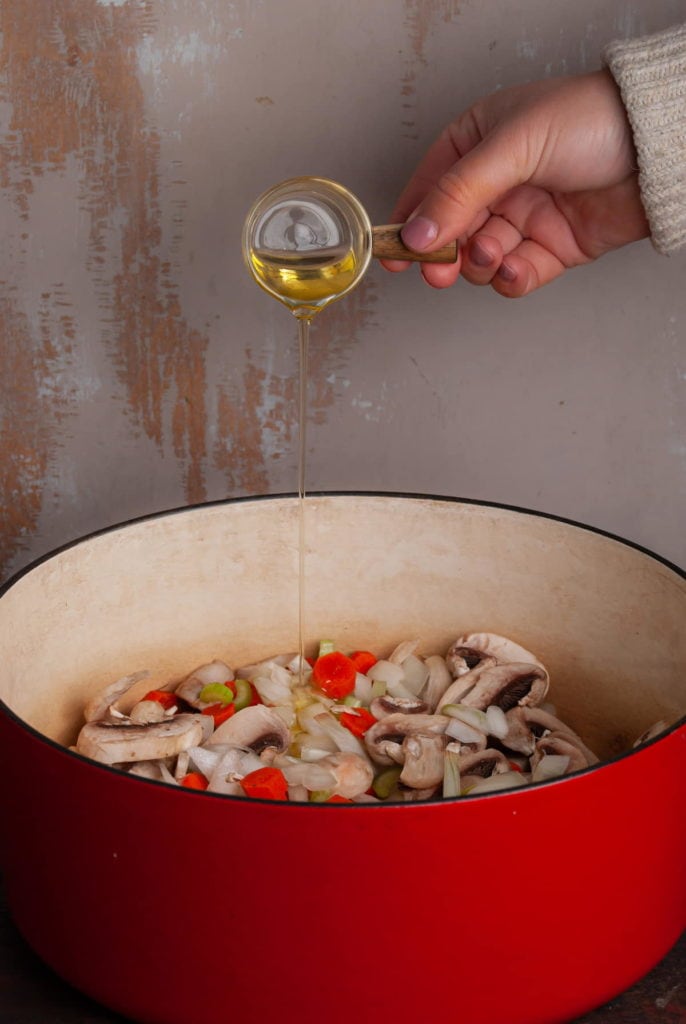 Adding Olive Oil to large Dutch Oven with onions, mushrooms, carrots, celery, and garlic