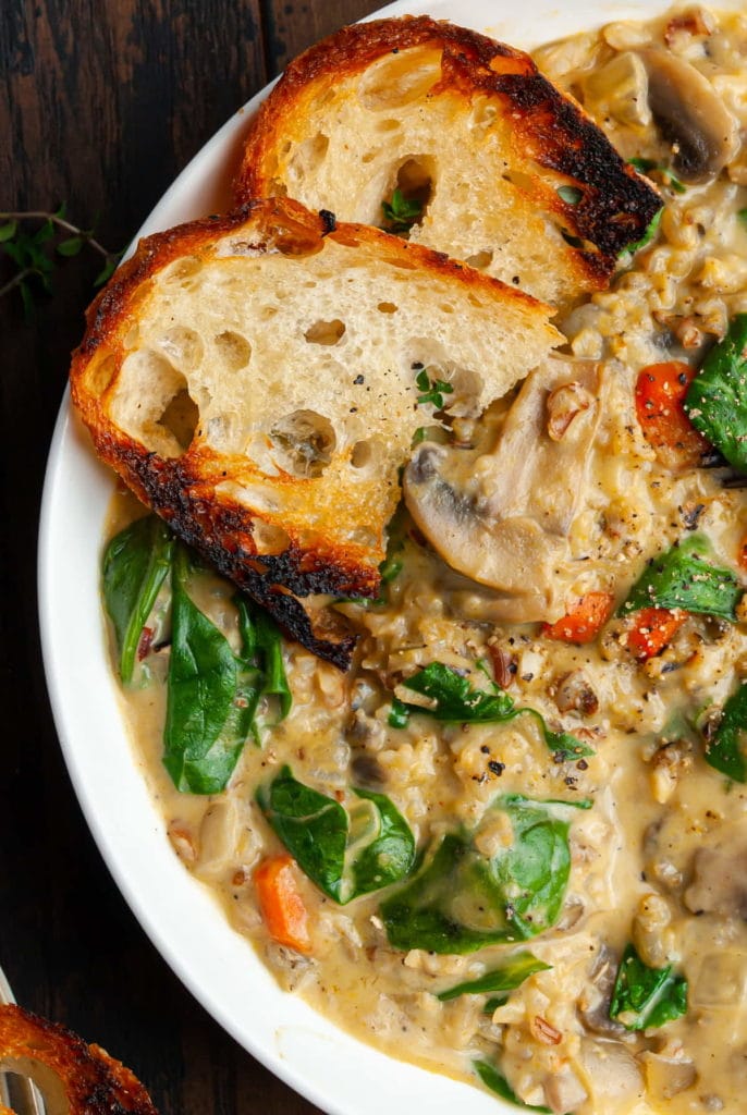 close up of wild rice soup with two pieces of toasted bread