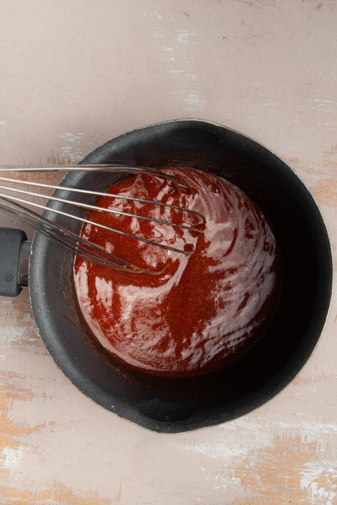 whisking bbq sauce in a pot