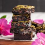 fudgy matcha brownies surrounded by bright pink flowers