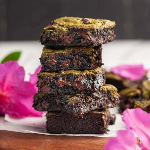 fudgy matcha brownies surrounded by bright pink flowers