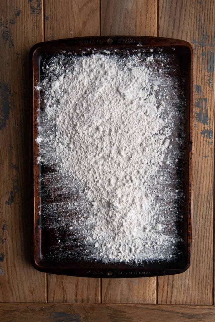 flour on a baking shett ready to be heat treated for cookie dough bites