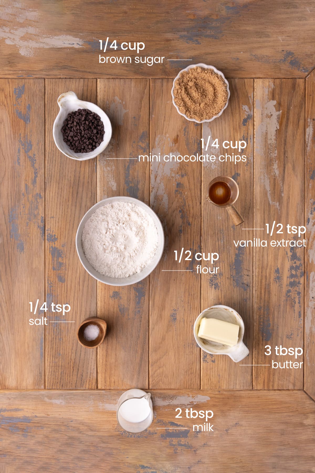 ingredients for no bake cookie dough bites - salt, flour, vanilla extract, brown sugar, mini chocolate chips, milk, granulated sugar, and butter