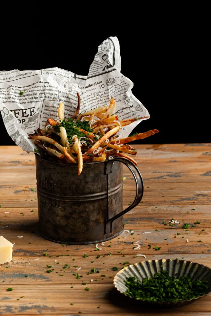 wooden table with a bucket of fries