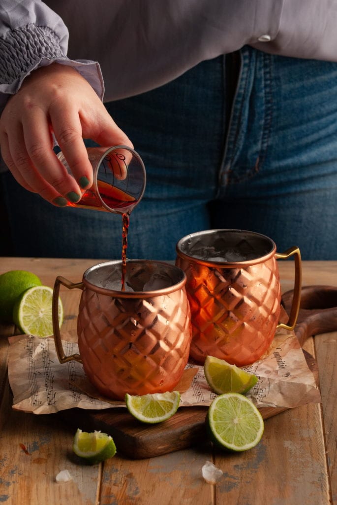 pouring Aperol into a Copper Mug