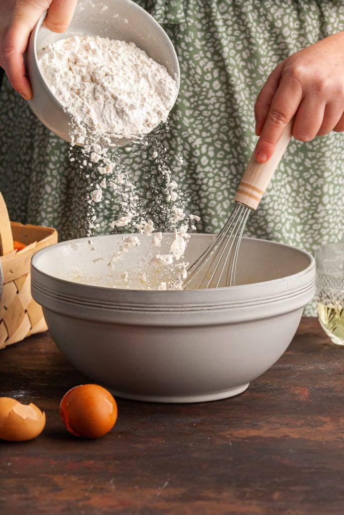 adding all purpose flour to muffin batter