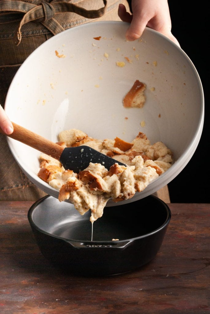 transferring bread pudding mixture to casserole dish