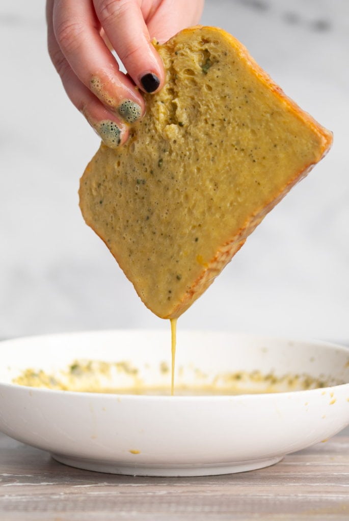 coating brioche bread in matcha egg wash to make french toast