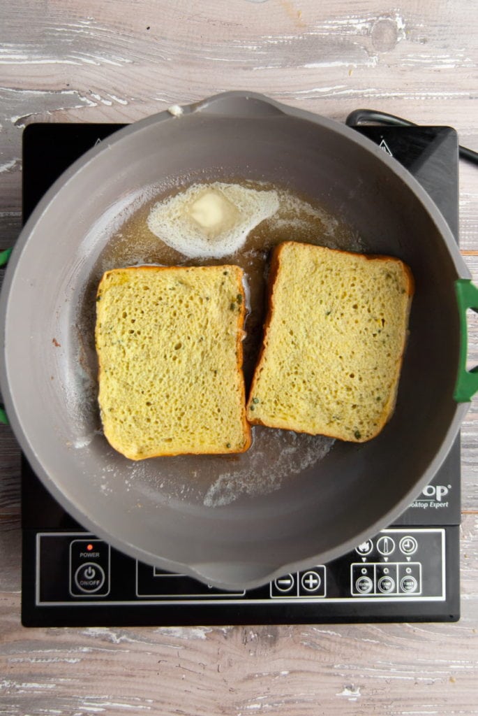 matcha french toast frying in a pan with butter