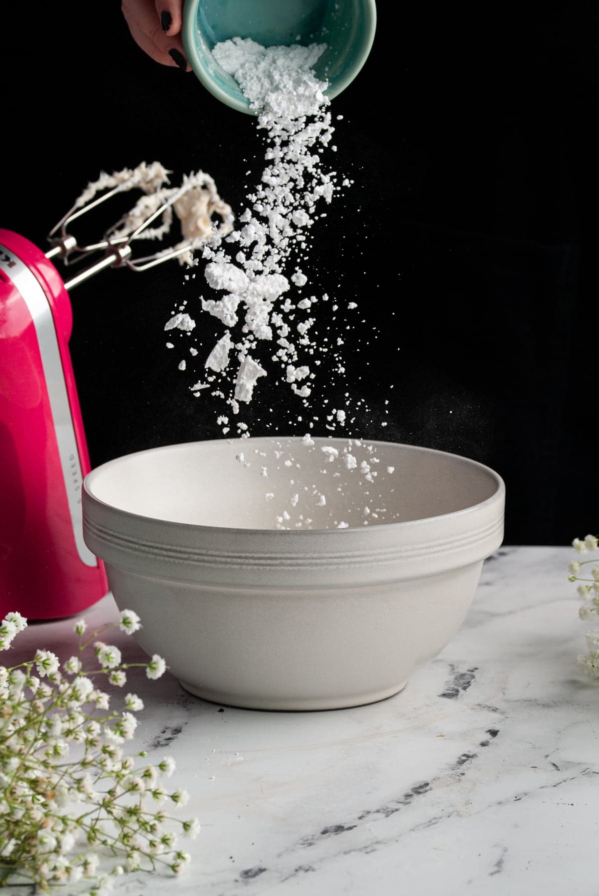 adding powdered sugar to cream cheese