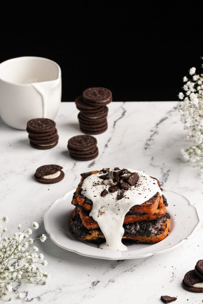 stack of oreo french toast with cookies behind it