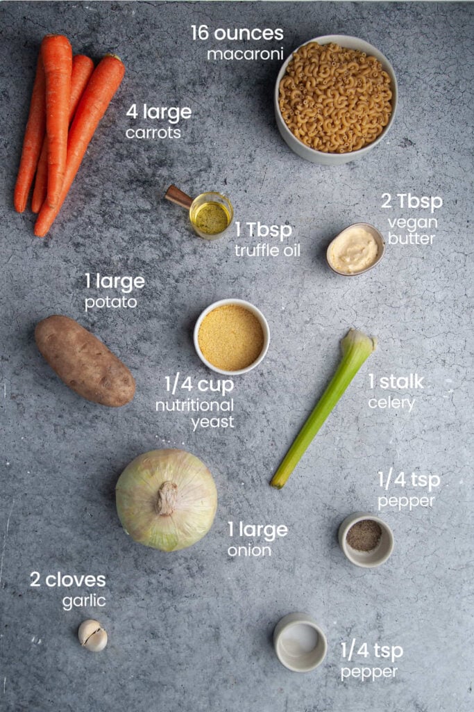 Everything you need to make Vegan Truffle Mac and Cheese including macaroni, carrots, truffle oil, plant-based butter, nutritional yeast, potato, celery, onion, pepper, salt, and garlic.