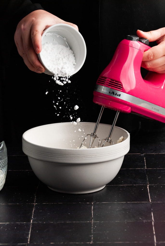 mixing together ingredients to make cream cheese icing