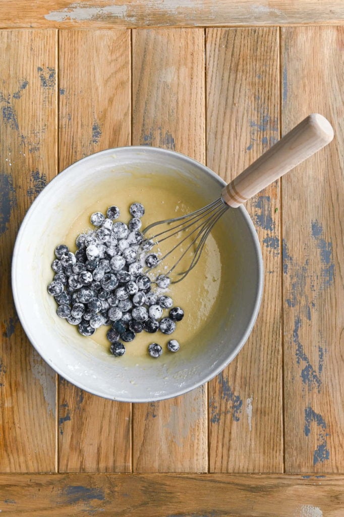 adding floured blueberries to muffin batter