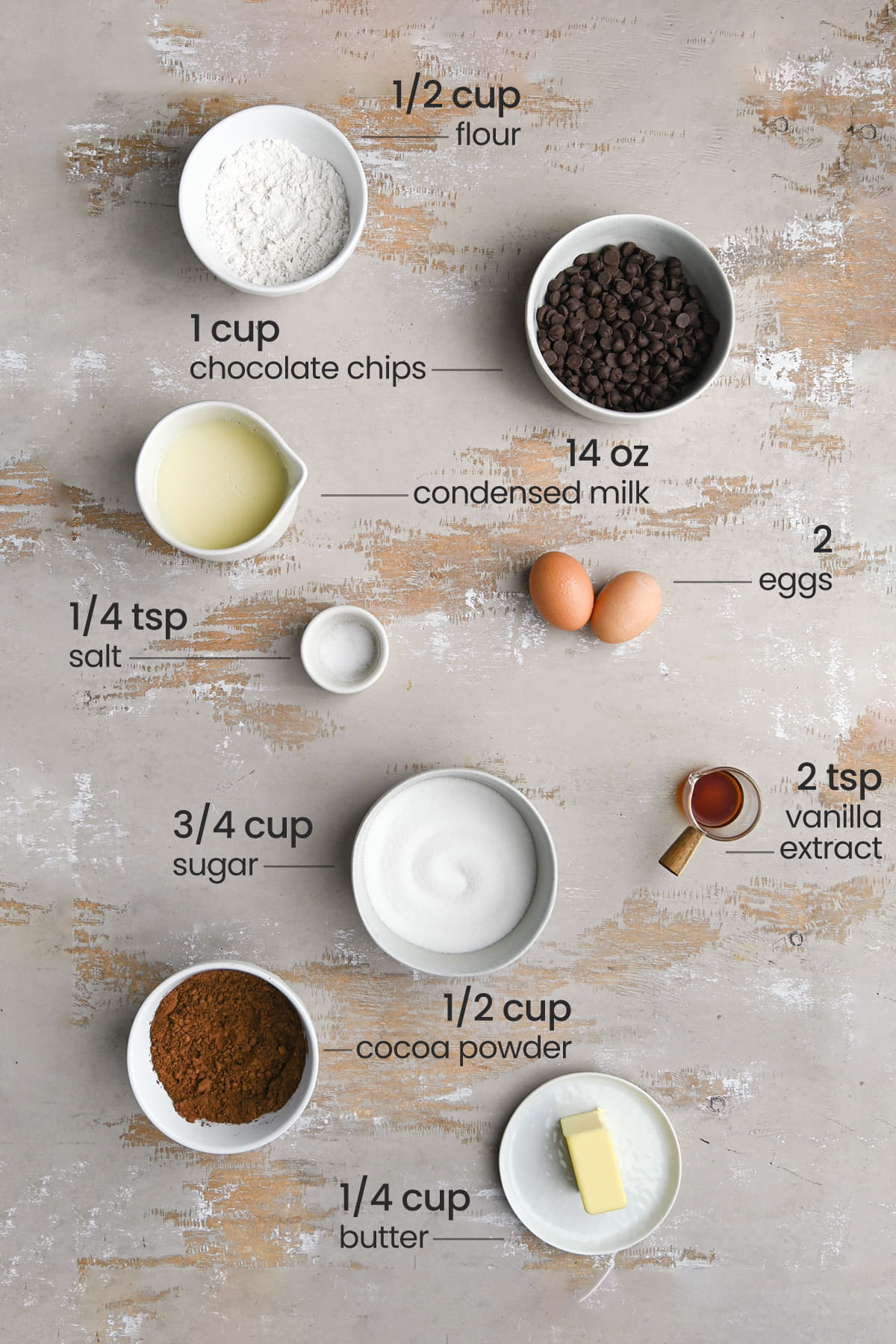 ingredients for condensed milk brownies - flour, chocolate chips, condensed milk, salt, eggs, sugar, vanilla extract, cocoa powder, butter