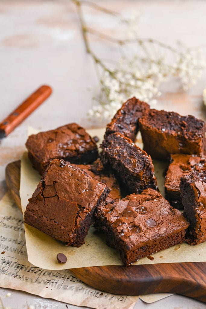 sliced condensed milk brownies all sitting on parchment paper at different angles