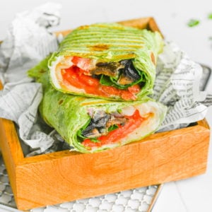 herbed cheese portobello mushroom wrap in a little box surrounded by graphic parchment paper