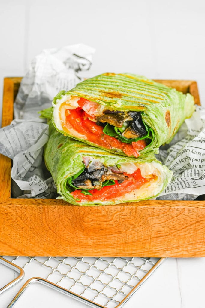 two halves of a portobello mushroom wrap stacked ontop of one another