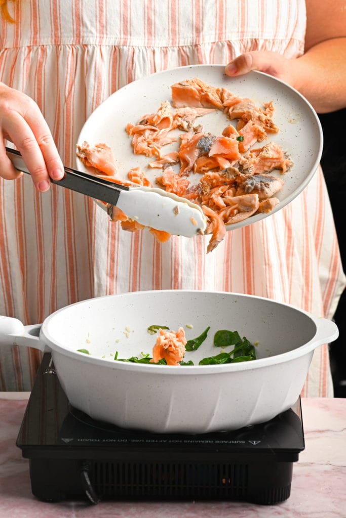 adding chopped salmon back into the pot