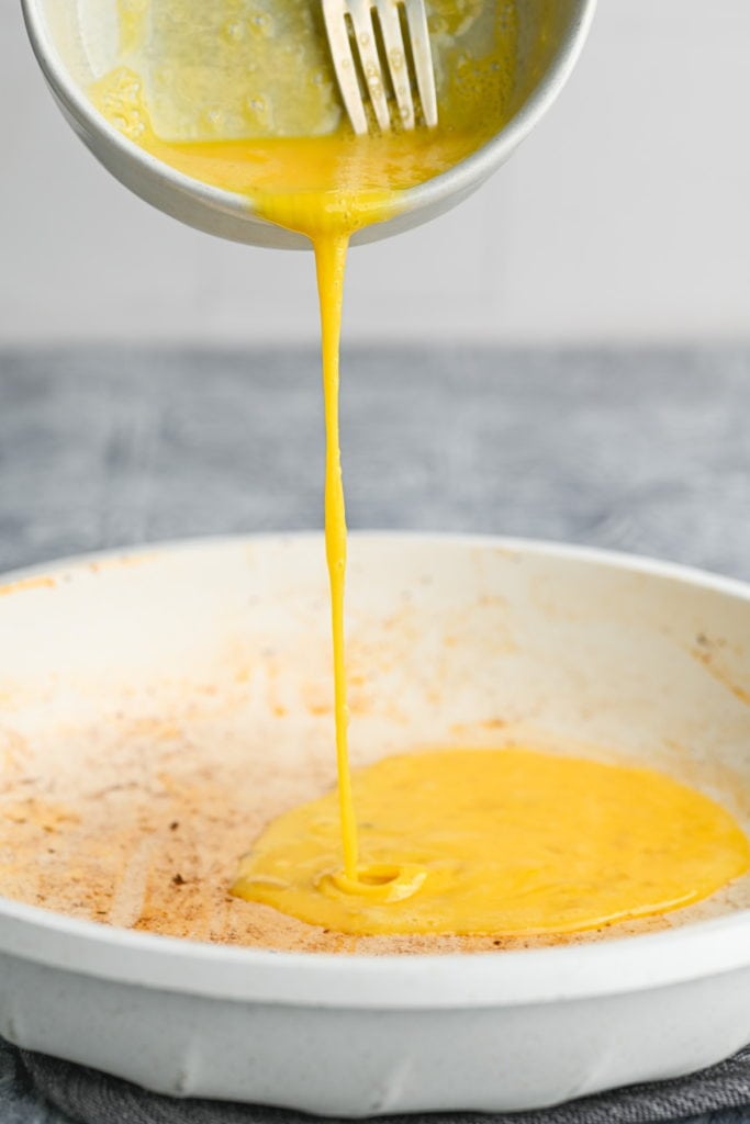 scrambling eggs in a hot pan