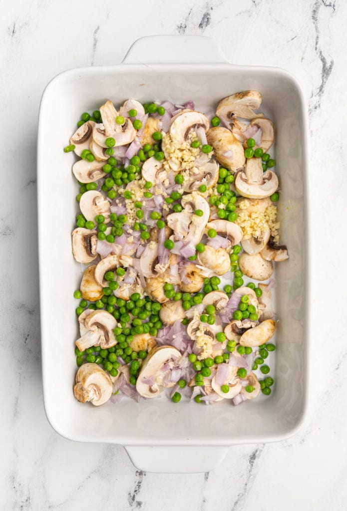 peas, shallots, mushrooms, and garlic in a casserole dish