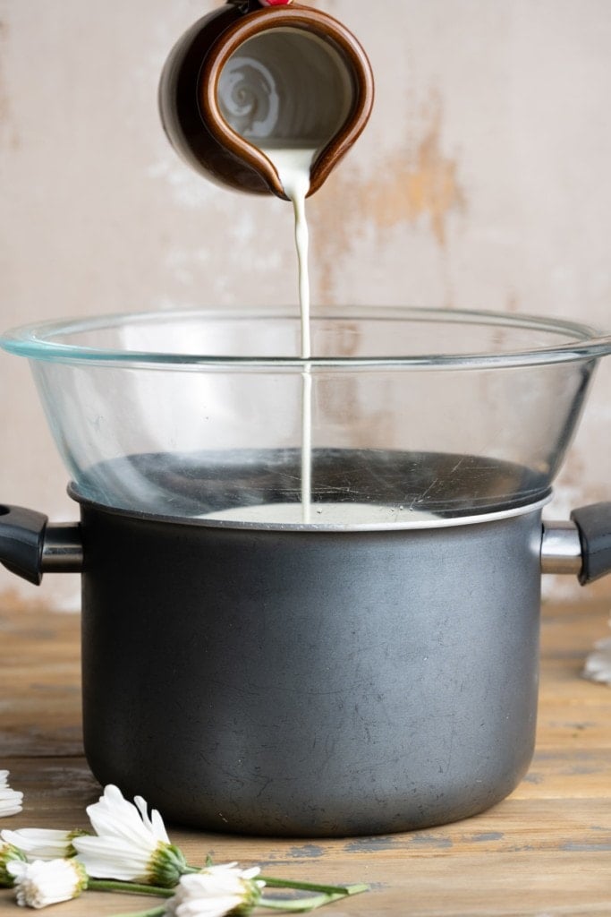 adding cream to a double boiler to safely heat it
