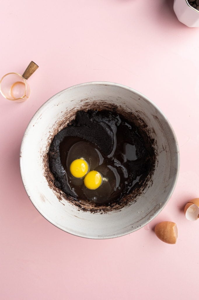adding eggs and vanilla extract to dairy-free brownie batter