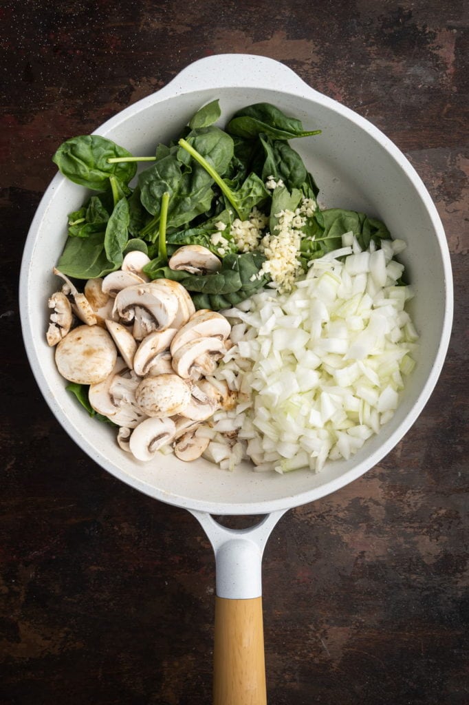 cooking spinach, mushrooms, onions, and garlic in olive oil, salt, and pepper