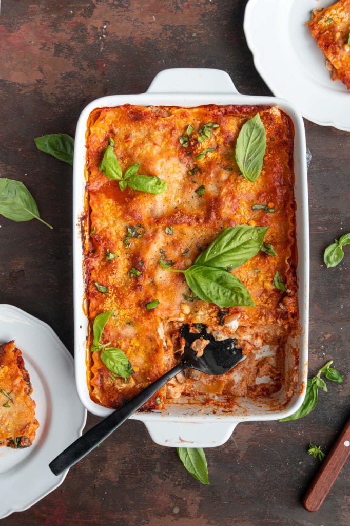 serving a slices of meatless lasagna on white plates