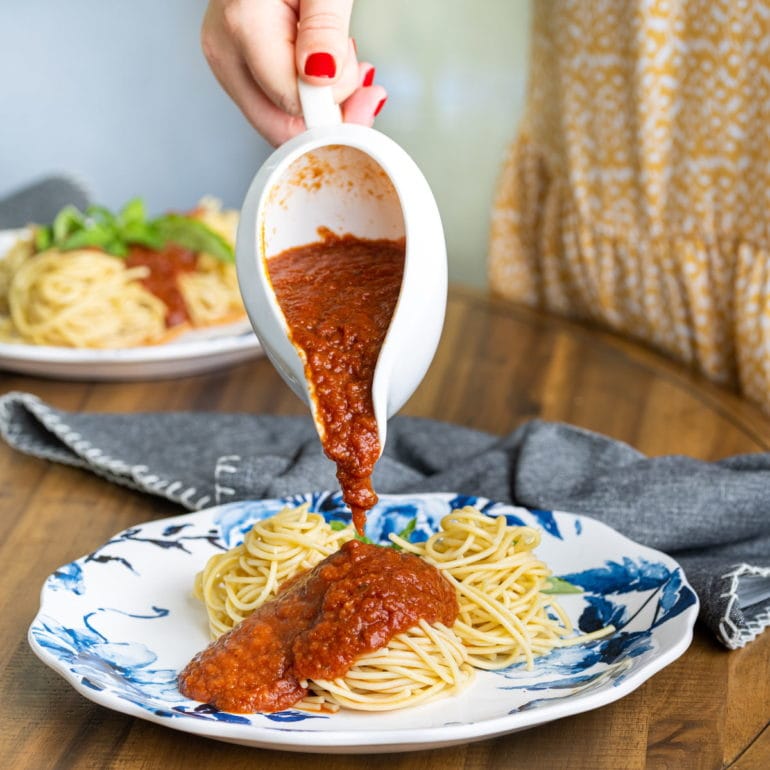 serving meatless spaghetti sauce overtop plain spaghetti