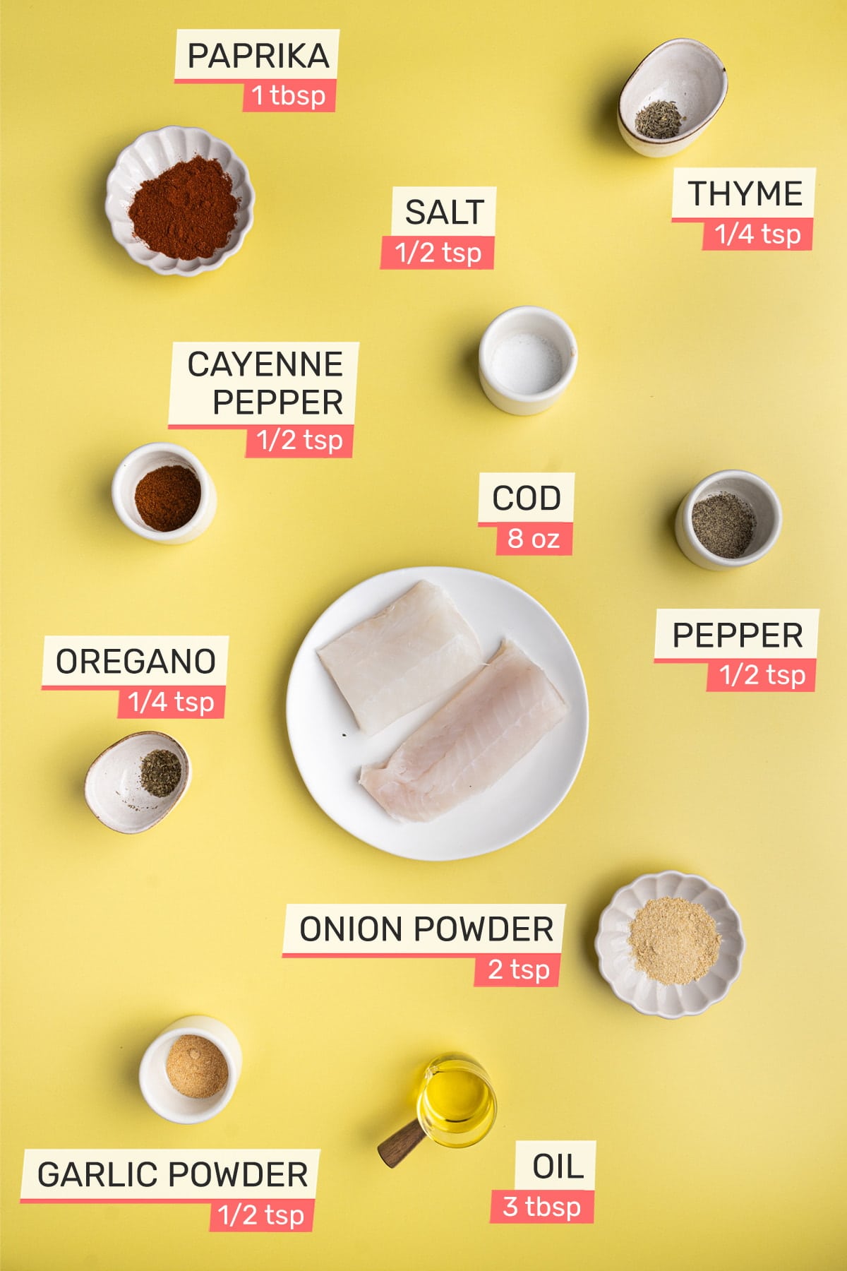 Overhead view of all ingredients for Blackened Cod - paprika, salt, thyme, cayenne pepper, cod, oregano, pepper, onion powder, garlic powder, oil