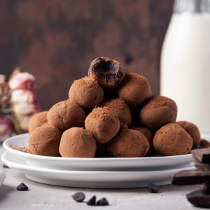 tower of chocolate truffles with one at the top with a bite taken out