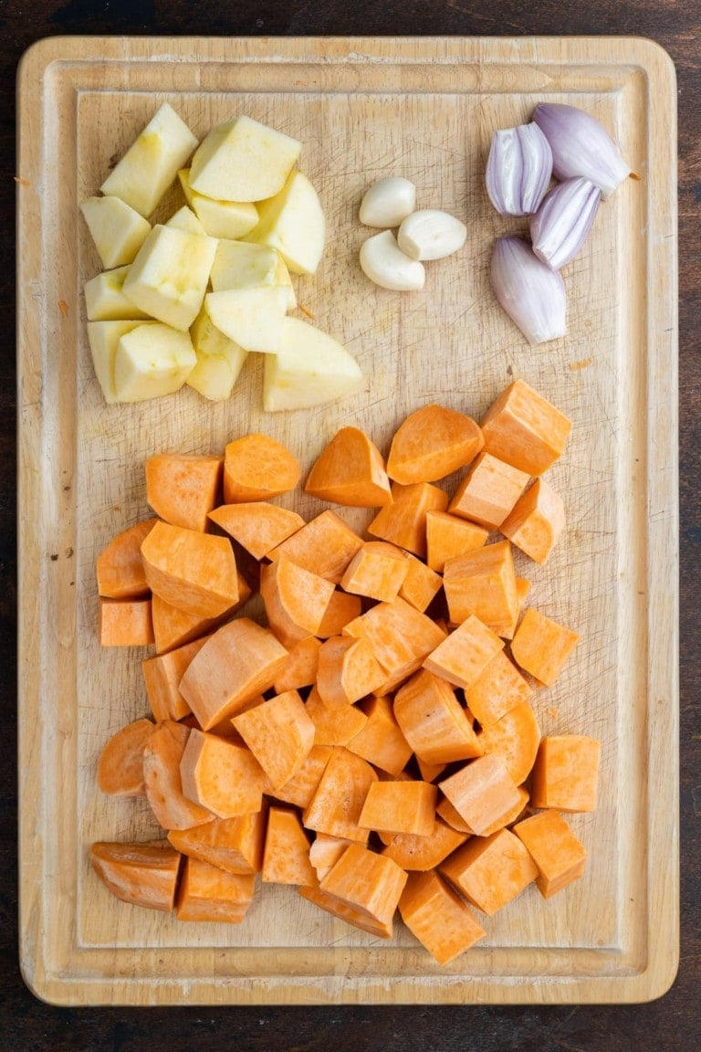 Apples, garlic, shallots, and sweet potato prepped to make soup.