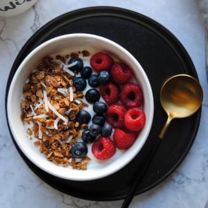 Overhead picture of a bowl of granola with berries and yoghurt