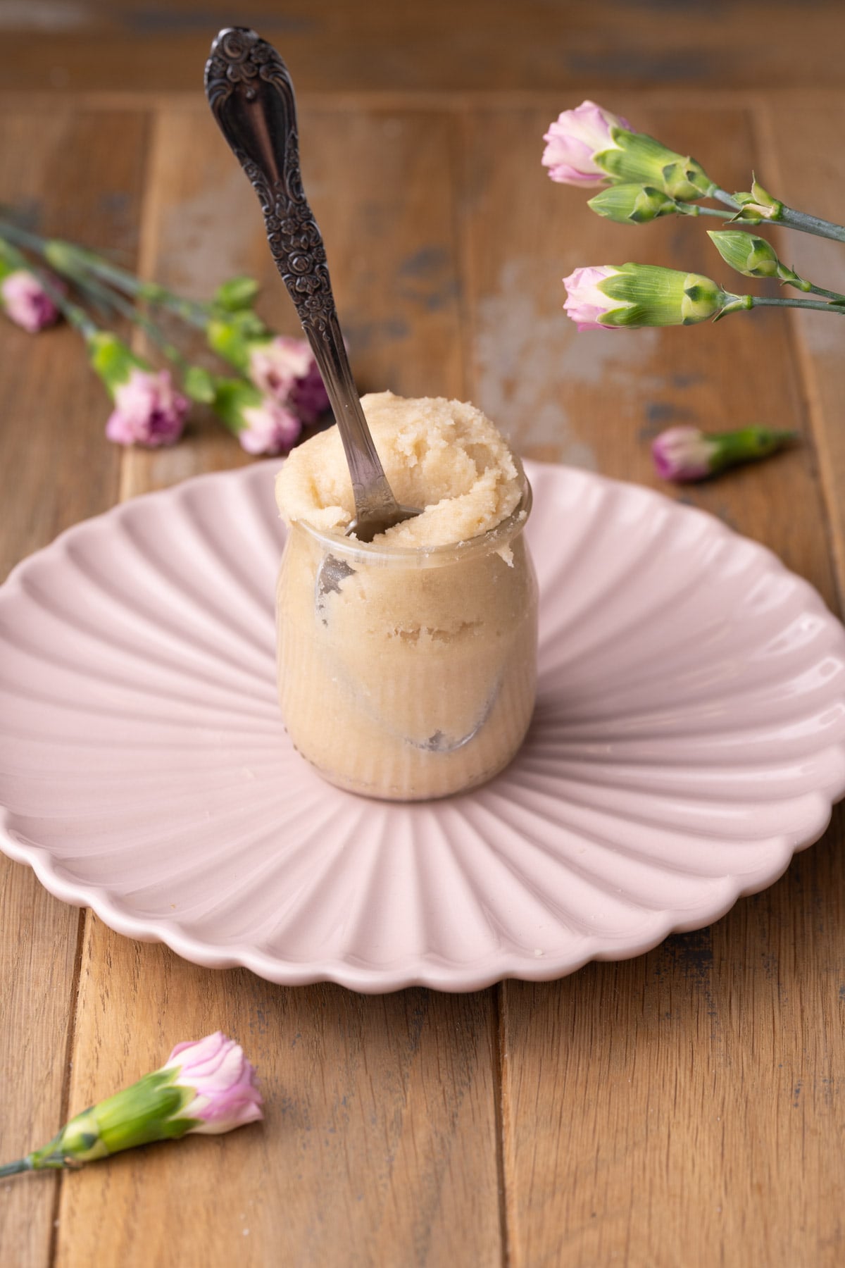 Silver spoon stuck into a jar of sugar cookie dough.