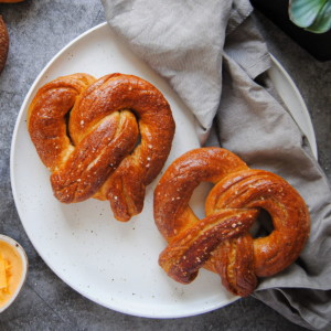 overhead view of 2 soft pretzels on a white plate
