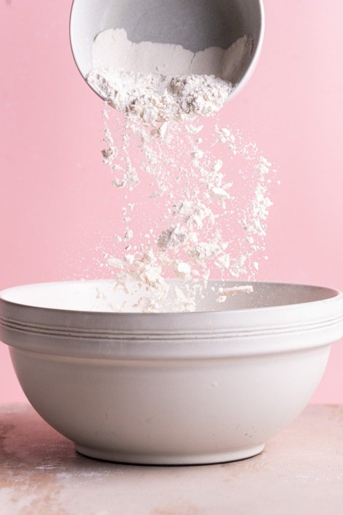 Adding all-purpose flour to large mixing bowl