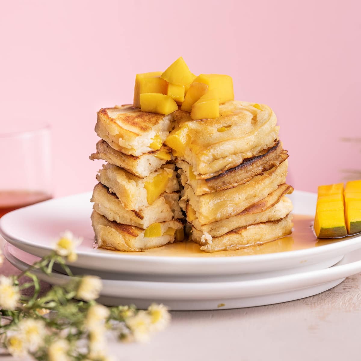 Stack of mango pancakes with slice taken out