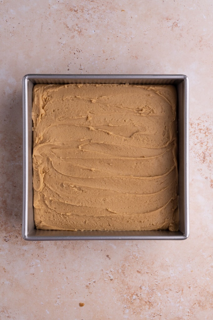 Spreading peanut butter fudge out in baking pan