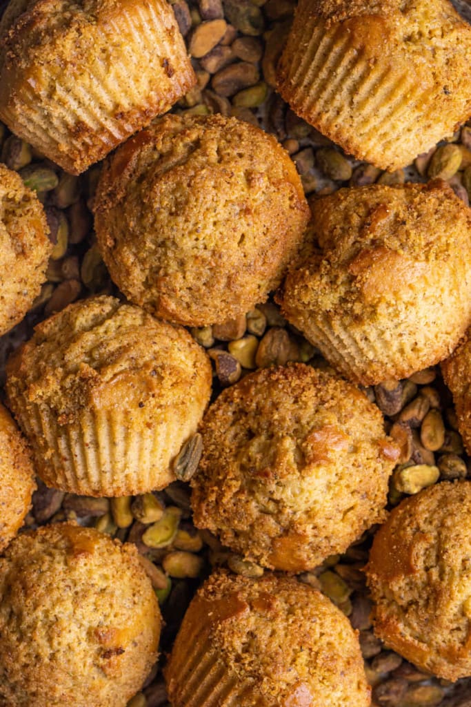 Close up of Pistachio Muffins surrounded by shelled pistachios