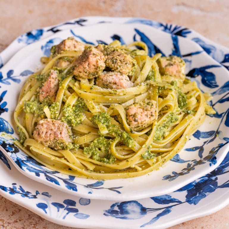 Salmon Pesto Pasta on blue and white plates