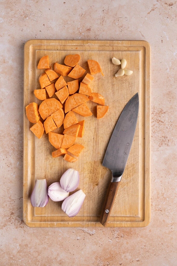 Prepped sweet potato, shallots, and garlic